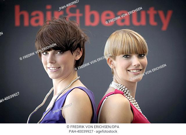 The models Ramona (R) and Vanessa present the new haircut trends 'Dr Bob' (L) and 'Aufgesetzter Bob' (R) ('Bob put on top') at the fair 'Hair and Beauty 2013'...