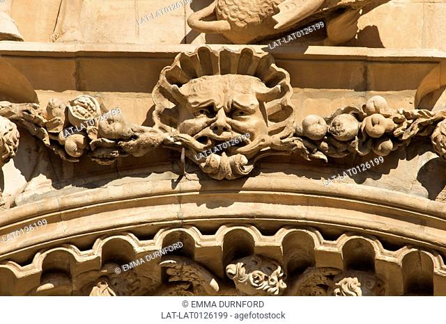 Green Man with fruit and a cherub below on the ornately carved front above the door of the sandstone thirteenth century built 1281-1317 gothic convent and...