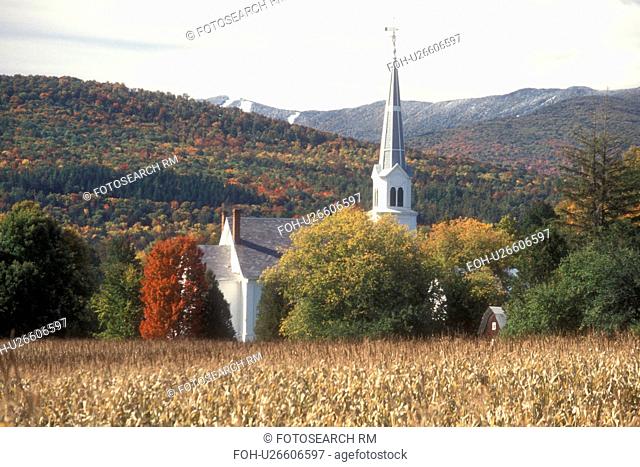church, fall, Waitsfield, VT, Vermont, Scenic view of the United Church of Christ surrounded by colorful fall foliage from a cornfield with the first snow on...