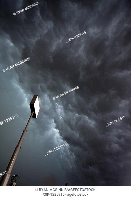 A large sign stands against the roiling clouds of a severe squall line overhead in Nebraska, May 24, 2010