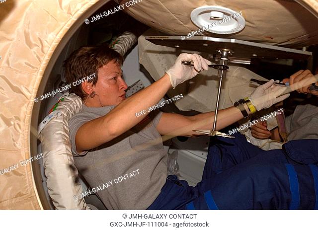 Astronaut Peggy Whitson, Expedition 16 commander, prepares to close the hatch in the Pressurized Mating Adapter (PMA-2) of the International Space Station after...
