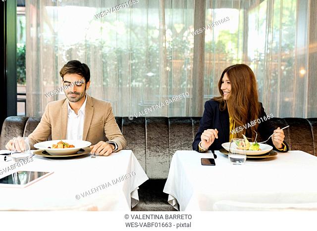 Smiling woman looking at man in a restaurant