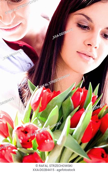 young couple with banch of tulips
