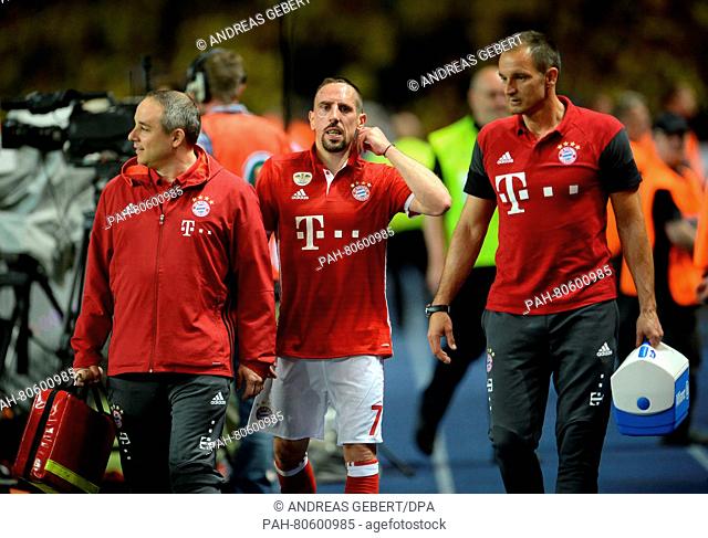 Munich's Franck Ribery (C) seen after being substituted due to an injury during the German DFB Cup final soccer match between Bayern Munich and Borussia...