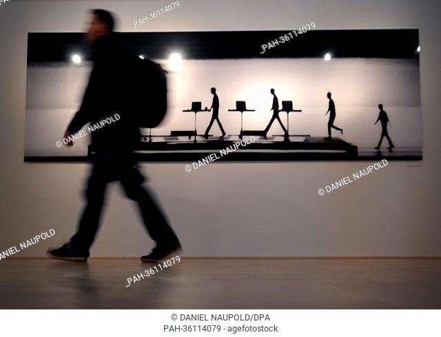 A man walks past the work 'Minimum-Maximum 2002' by Peter Boettcher at the exhibition 'Kraftwerk - Robots - Photography Peter Boettcher' at NRW-Forum in...