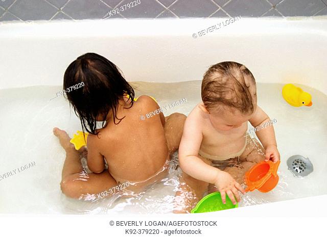 2-year-old Vietnamese girl and 1-year-old American boy in a bathtub