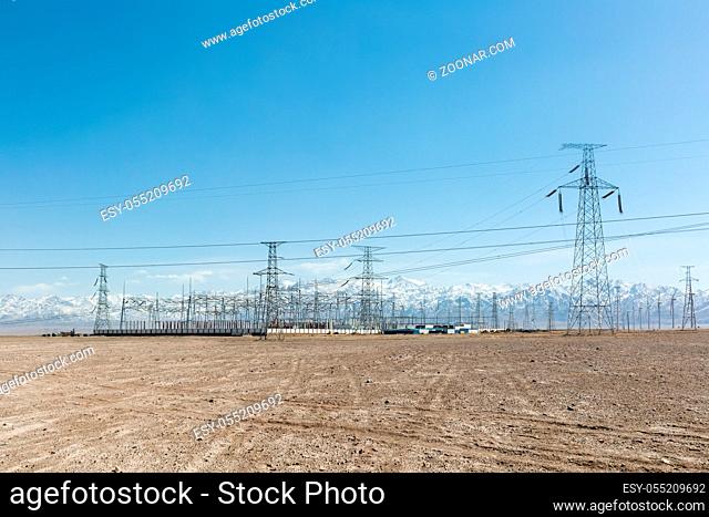 clean energy substations on wilderness with snow mountains background