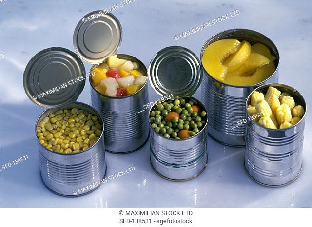 Several opened tins of vegetables and fruit