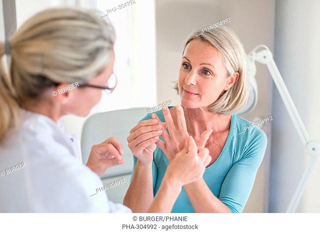 Doctor examining hand of a patient
