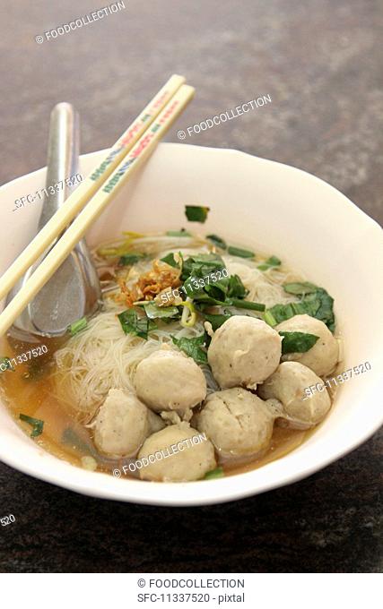 Noodle soup with meatballs and coriander