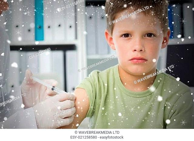 Boy receiving an injection by pediatrician
