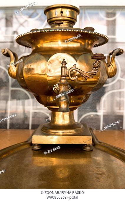 Old russian bronze tea samovar on tray