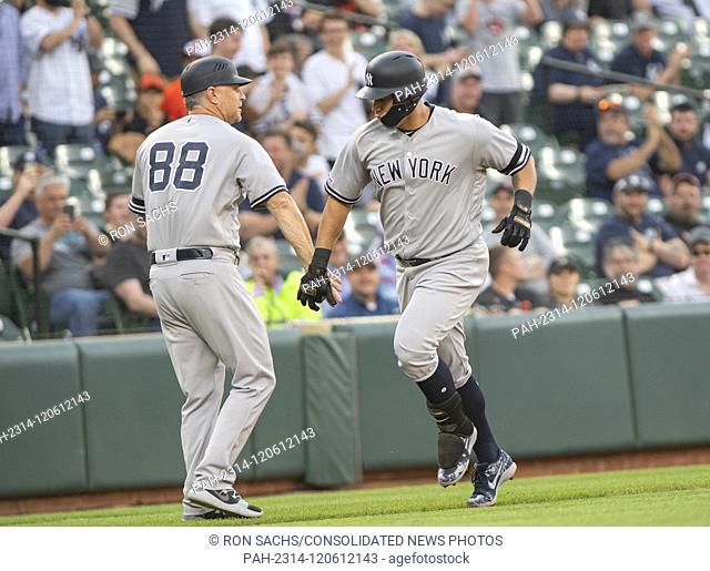 New York Yankees catcher Gary Sanchez (24), right, celebrates his first inning three-run home run with third base coach Phil Nevin (88) against the Baltimore...