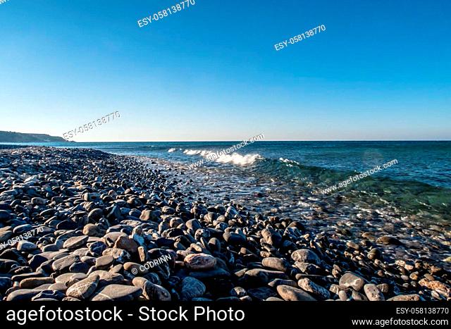 Seashore with stones and little waves