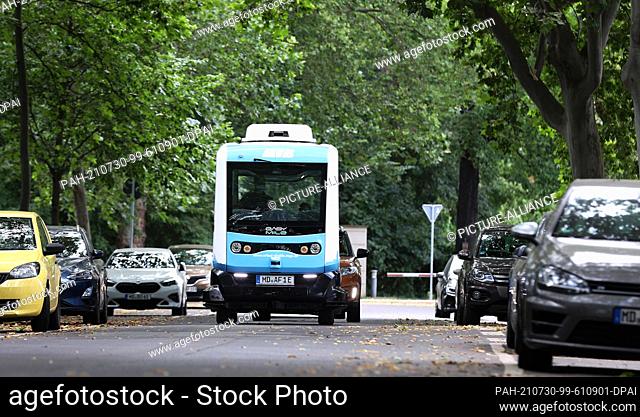 29 July 2021, Saxony-Anhalt, Magdeburg: The French EZ10 minibus, an autonomous shuttle bus, drives through the old town of Magdeburg during a test run