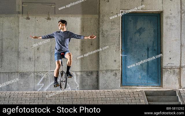 Teenager, 19 years old, rides a unicycle, Germany, Europe