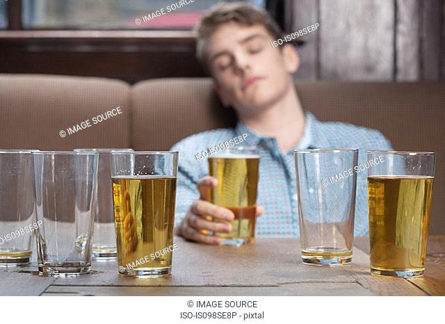 Young man asleep in bar