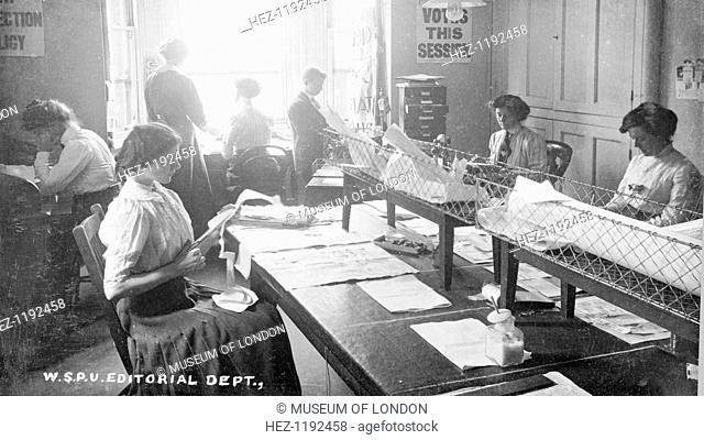 The editorial department, Clement's Inn, The strand, September 1911. That week's edition of Votes for Women is being cut and pasted by the young woman volunteer...