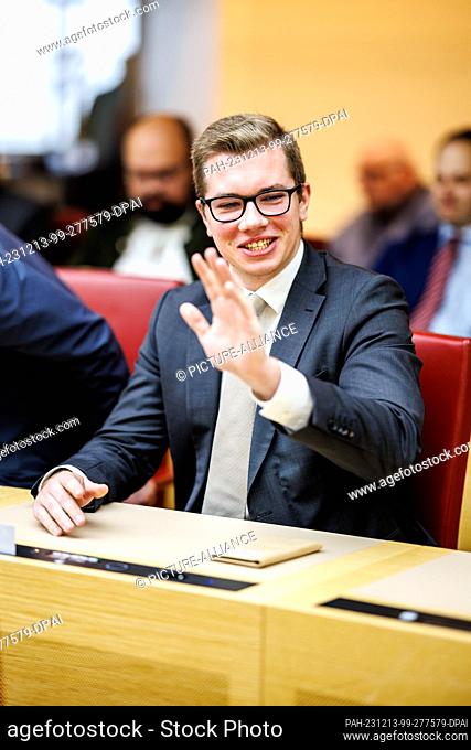 12 December 2023, Bavaria, Munich: Daniel Halemba, AfD member of the Bavarian state parliament, sits in his seat at the start of the last plenary session before...