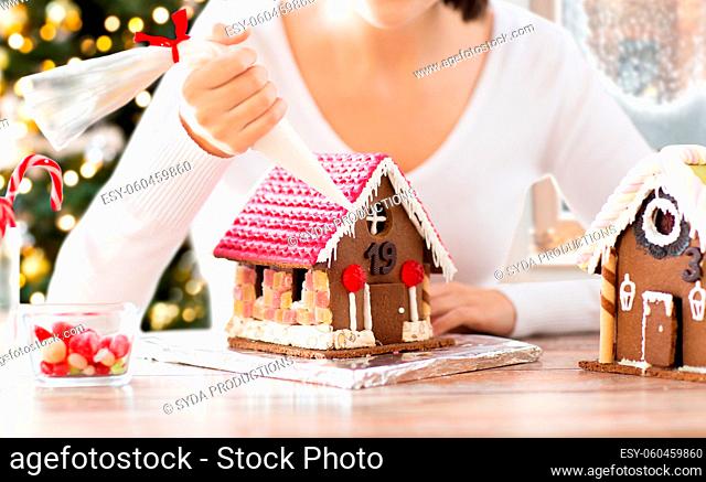close up of woman making gingerbread house