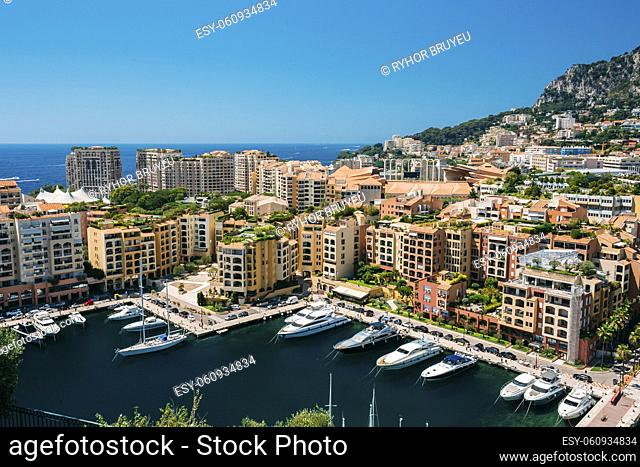 Yachts moored near city Pier, Jetty In Sunny Summer Day. Monaco, Monte Carlo architecture