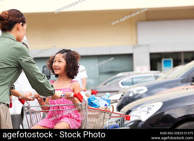Daughter and mother with shopping cart