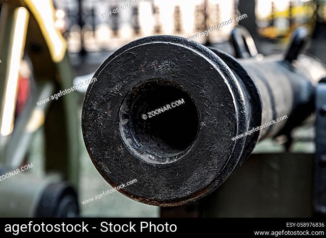 trunk of a heavy cast-iron gun close up, smooth-bore cannon
