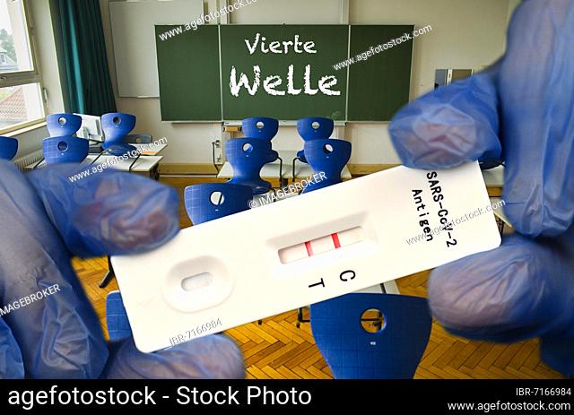 PHOTOMONTAGE, positive antigen rapid test, blackboard with inscription FOURTH WAVE, classroom, Corona crisis, Germany, Europe