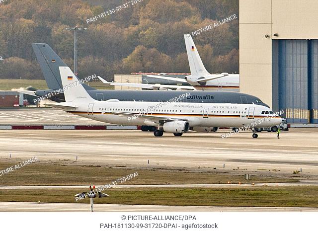 30 November 2018, North Rhine-Westphalia, Köln: The tail of the government aircraft Airbus A340-300 ""Konrad Adenauer"" can be seen behind two other aircraft on...