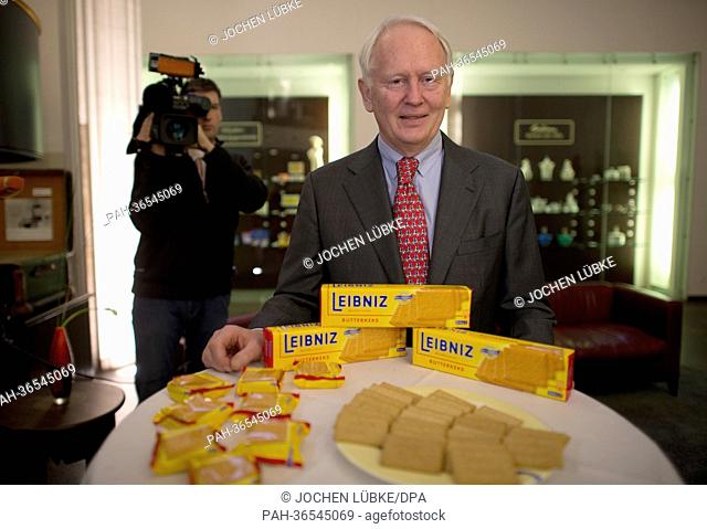 Bahlsen CEO Werner Michael Bahlsen stands on a table displaying Leibniz cookies at the company's headquarters in Hanover, Germany, 30 January 2013
