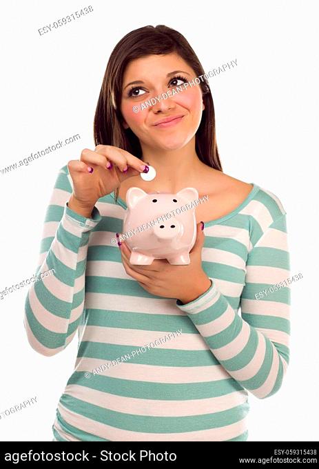 Pretty Smiling Ethnic Female Putting a Coin Into Her Pink Piggy Bank Isolated on a White Background