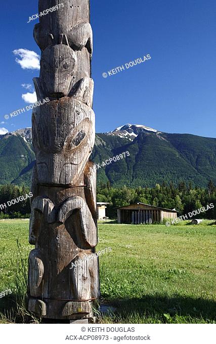 Totem pole and mountains at Kitwanga, British Columbia, Canada