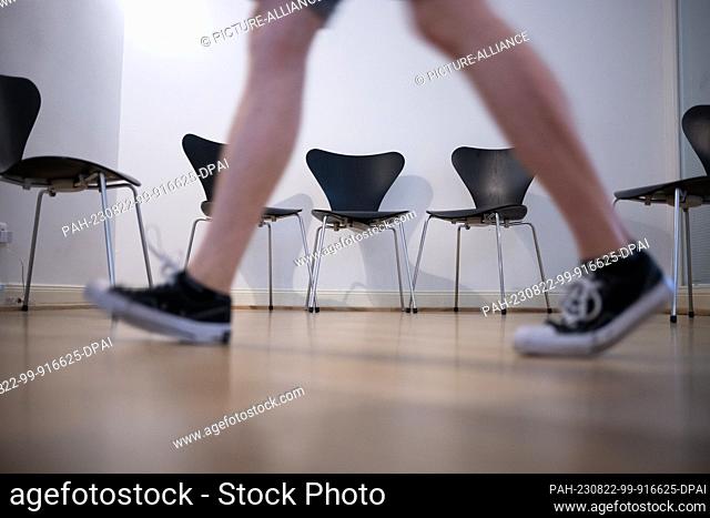 22 August 2023, Berlin: A man walks through the waiting room during a press appointment at an ENT practice. The Association of Statutory Health Insurance...