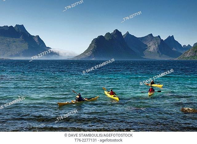Kayaking the beautiful waters of the Reinefjord in the Lofoten Islands, Norway