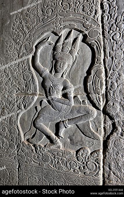 Bas-relief of a dancing Apsara (celestial dancer) at Angkor Wat temple complex. Angkor Archaeological Park, Siem Reap Province, Cambodia