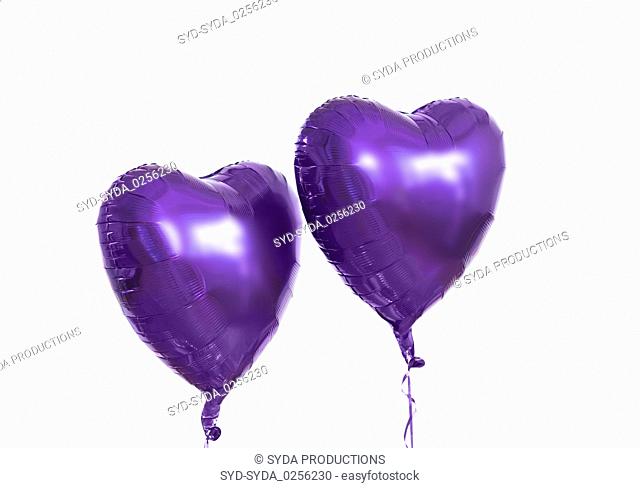 close up of helium balloons over white background