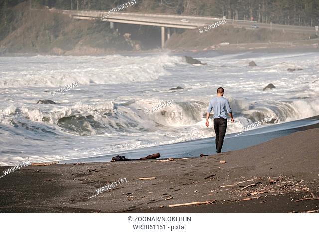 Lone man at USA Pacific coast beach