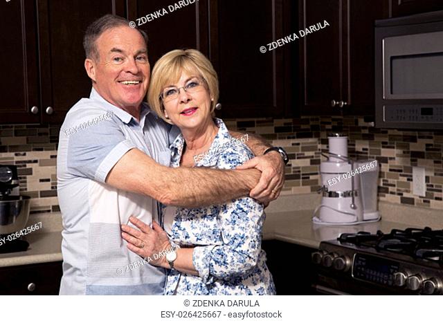 retired couple wearing casual outfits in the kitchen