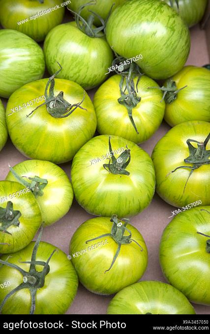 Green Tomatoes in Box on Market Stall