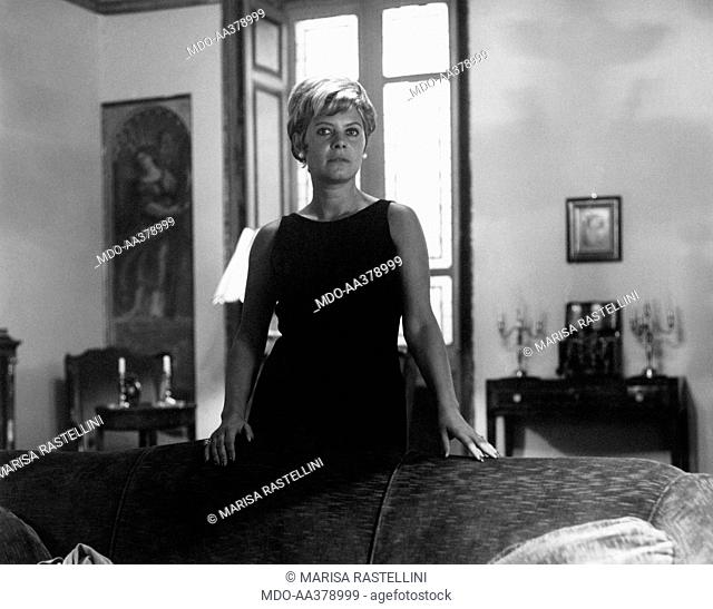 Lianella Carell beside a couch. Italian actress and journalist Lianella Carell posing beside a couch. Rome, 1963