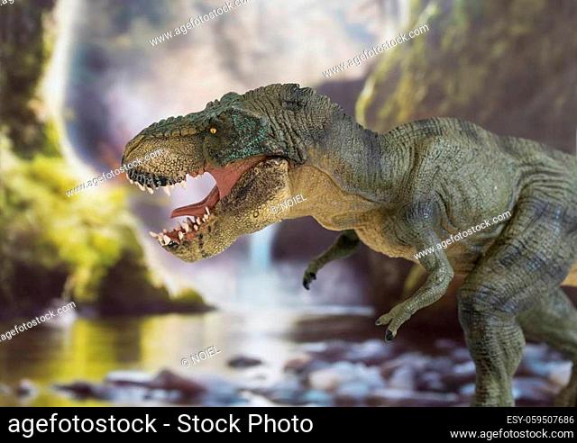 Tyrannosaurus with open mouth in cretaceous era with waterfall in the background. Lateral view