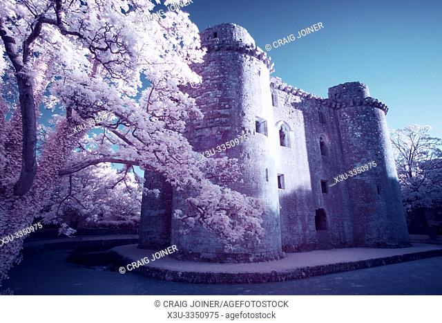 A false colour infrared image of Nunney Castle and moat in the village of Nunney, Somerset, England
