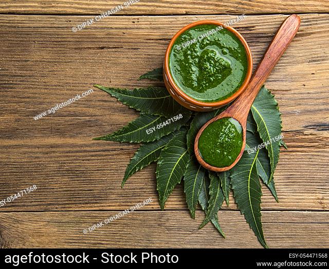 Medicinal Neem leaves with paste on wooden background