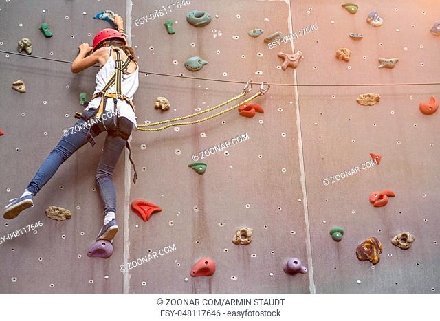 teenage girl in a free climbing wall