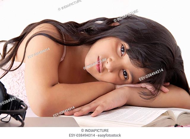 Girl resting on textbook