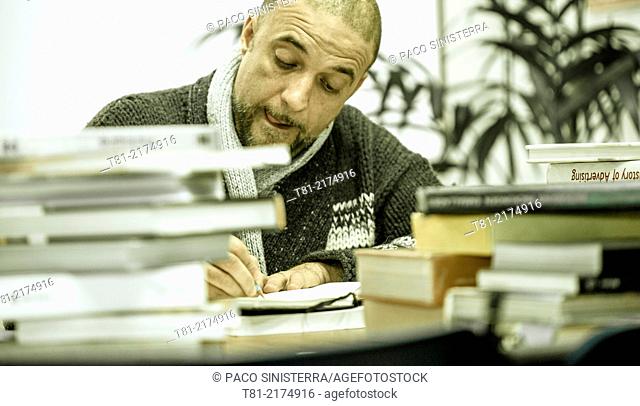 designer preparing a job with books