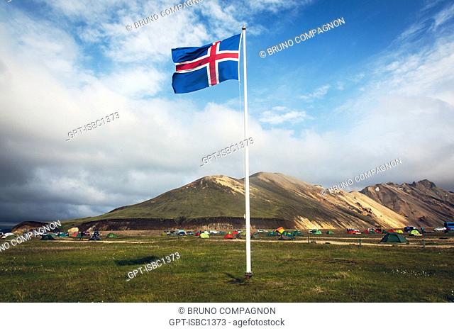ICELANDIC FLAG WAVING OVER THE CAMPSITE OF LANDMANNALAUGAR, VOLCANIC AND GEOTHERMAL ZONE OF WHICH THE NAME LITERALLY MEANS 'HOT BATHS OF THE PEOPLE OF THE LAND'