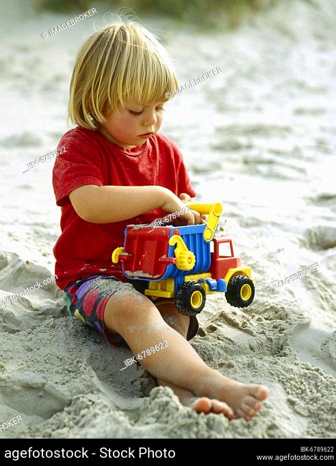Little girl playing in the sandbox Photo:
