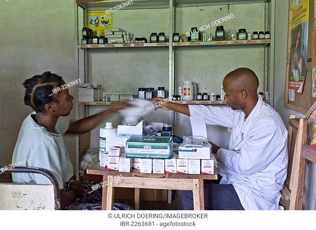 Patient receiving anti-retroviral medicines in an HIV-AIDS clinic from a pharmacist, Quelimane, Mozambique, Africa