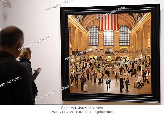 Participants of a press conference look at the work ""Grand Central Terminal: An Early December"" by S. Roberts from 2009-2012 at the exhibition ""The American...